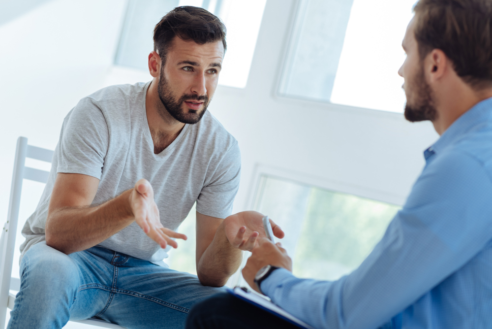 man talking to a counselor for dual diagnosis