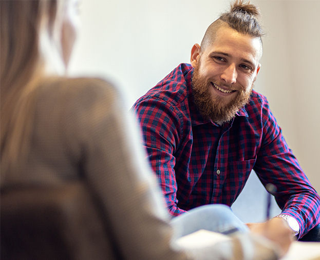 white man in individual therapy smiling at counselor