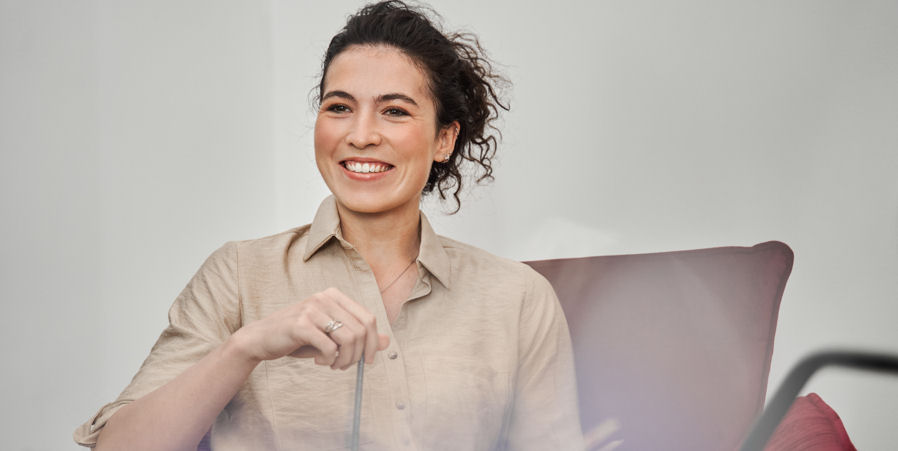 woman smiling while sitting in a chair