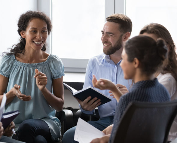 young woman comforting man in group session