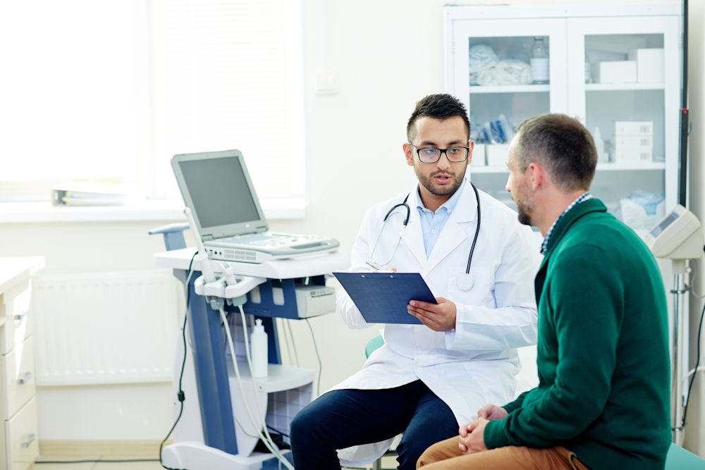 a doctor explaining to a patient the proper diet during detox